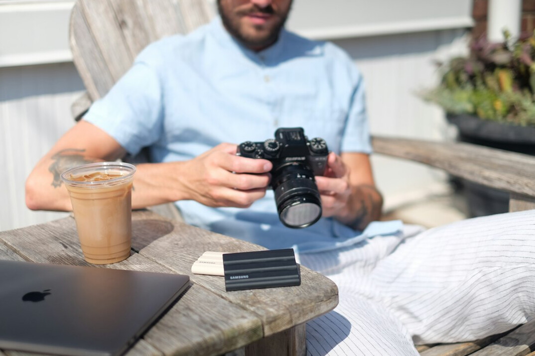 Photographer interviewing a resident with a notebook and camera
